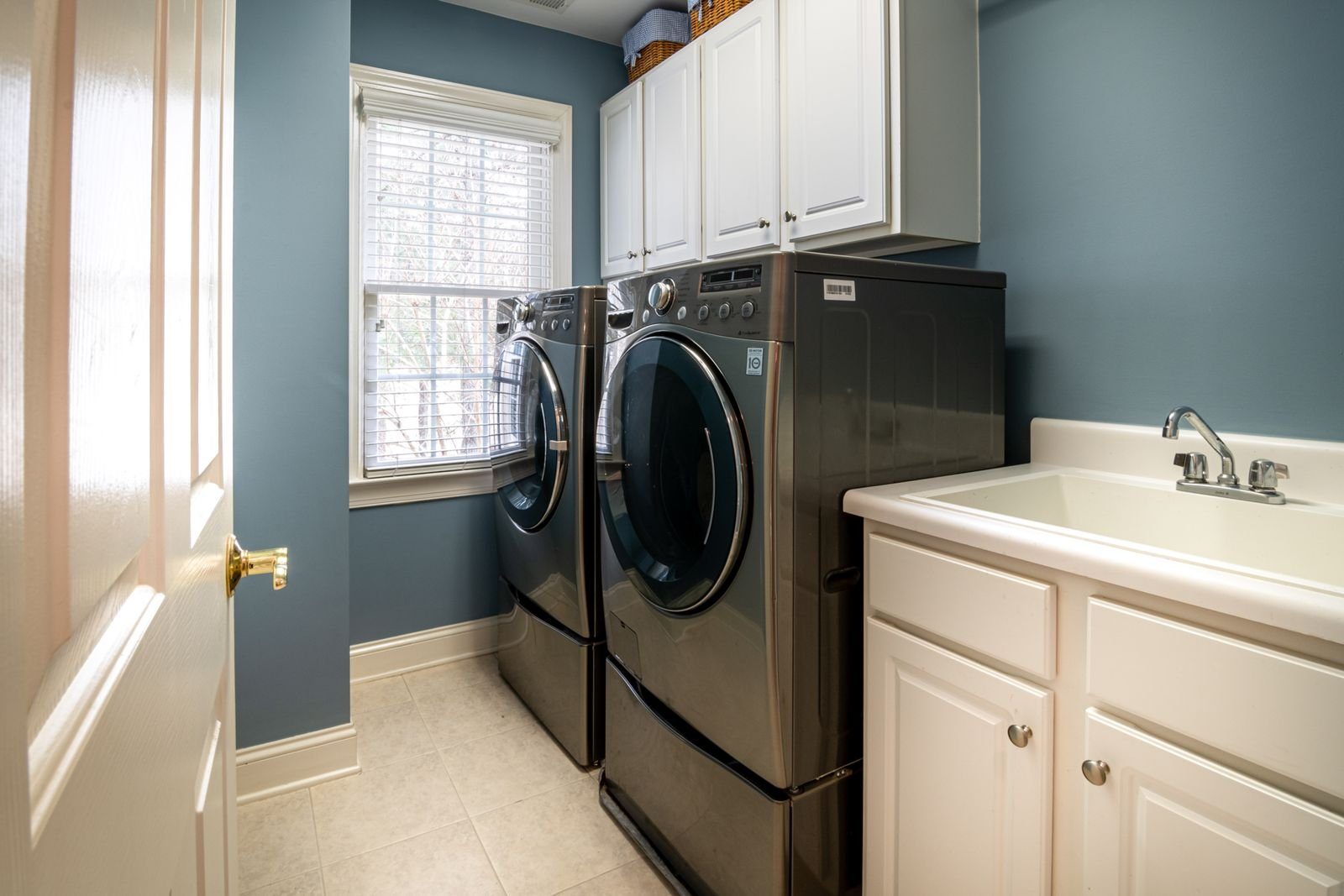 Washer and dryer in a blue walled home laundry room